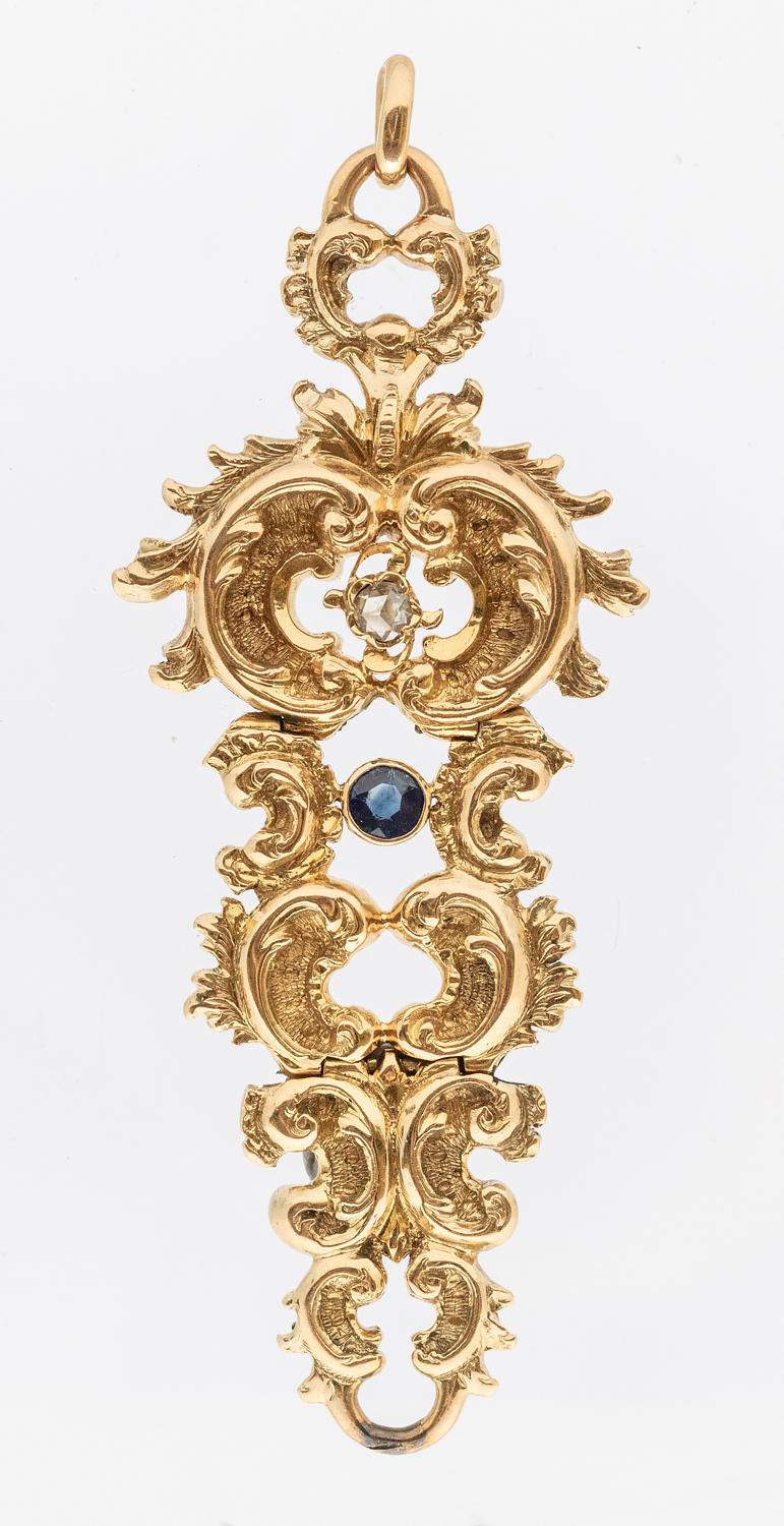 A Victorian sapphire and diamond drop gold pendant, comprising cuir roule gold motifs set to the