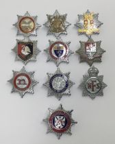 A selection of vintage chromed and enamelled fire service cap badges. To include: Kings crown