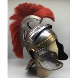 A reproduction Roman legionaries Galea helmet. Constructed in steel, with brass ornamentation, and a