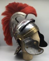 A reproduction Roman legionaries Galea helmet. Constructed in steel, with brass ornamentation, and a