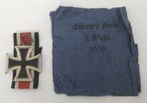 A WW2 Iron Cross 2nd class, complete with ribbon and the remains of an original paper envelope. An