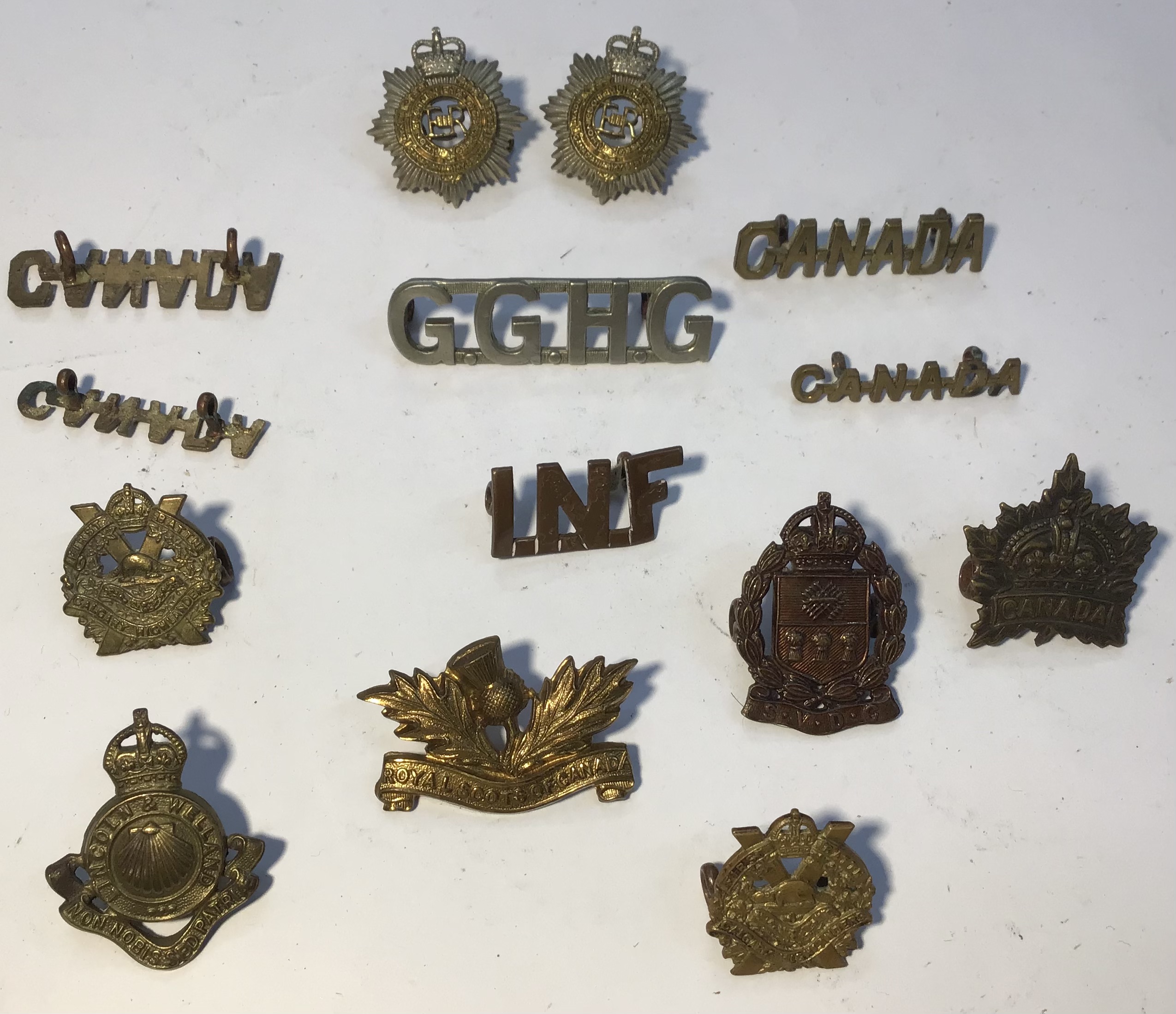 A selection of Canadian Military Uniform badges and shoulder titles.