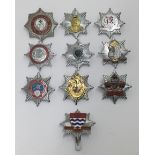 A selection of vintage chromed and enamelled fire service cap badges. To include: Powys Fire