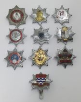 A selection of vintage chromed and enamelled fire service cap badges. To include: Powys Fire