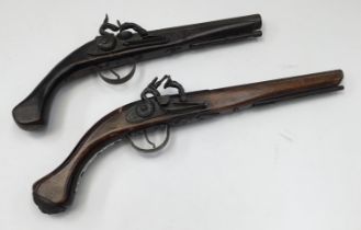 Two inert replica flintlock pistols (similar but not matching pair) cast parts with moving locks but