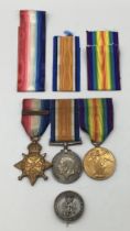 A WW1 1914 star trio, with sewn on clasp and silver war badge. Awarded to 2799 Dvr Edwin Arthur Fern