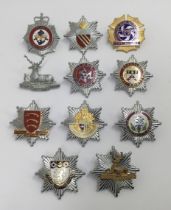 A selection of vintage chromed and enamelled fire service cap badges. To include: Hertfordshire Fire