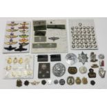 A selection of various military badges, and other items. To include: a board containing modern cap