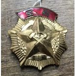 A Rare North Korean Order of Labour, in gilt metal and enamel. With pin attachment to the reverse