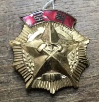 A Rare North Korean Order of Labour, in gilt metal and enamel. With pin attachment to the reverse
