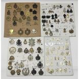 A selection of British military cap badges, and collar badges. Comprising of volunteer battalions,