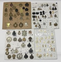 A selection of British military cap badges, and collar badges. Comprising of volunteer battalions,