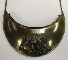 A 19th century French gilt brass gorget, with silvered eagle, black broadcloth backing, and neck