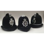 3 vintage British Police helmets, each with chromed badges applied to the fronts. To include: a