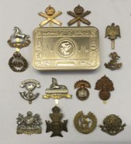 A selection of brass and bi-metal cap badges, plus a WW1 centenary Princess Mary tin (produced in