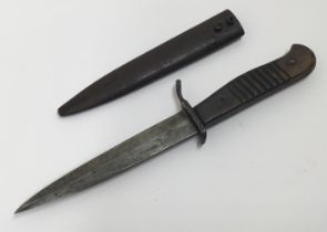 A WW1 era, German trench or boot knife. Of standard form, with shaped wooden slab grips, with each