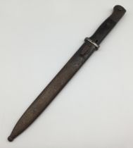 A pre WW2 German K98 bayonet, dated 1938 to the spine of the blade. Complete with wooden slab grips,