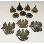 A selection of WW1 and earlier German pickelhaube spare parts. To include 4 helmet plates, one in