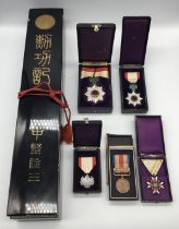 A good collection of WW2 era Japanese awards and decorations. 4 are complete with their original