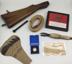 A selection of WW1 / WW2 military related items. To include: a Lee Enfield rifle stock, with