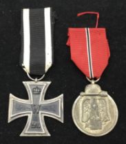 A WW1 German Iron Cross 2nd class, complete with original ribbon. Maker marked S.W to the suspension