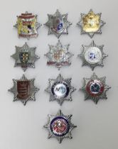 A good selection of vintage chromed and enamelled fire service cap badges. To include: Newcastle