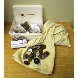 A collection of old threepence coins and slot machine tokens used for amusement machines. One box