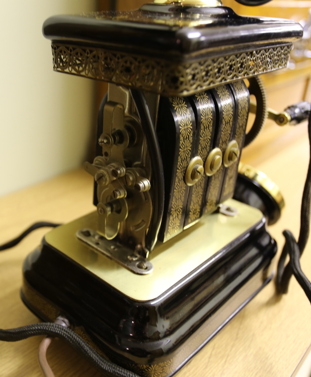 A 20th century ornate crank telephone, Expoga, Denmark with black enamel and gilt decoration. Please - Image 6 of 6