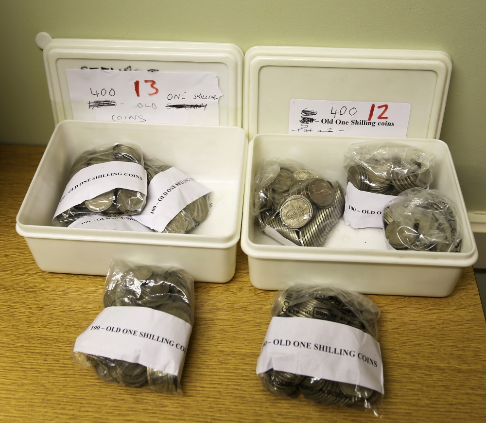 A collection of old One Shilling coins used for amusement machines. Two small boxes. Approx. 800.