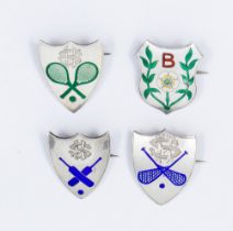 A collection of shield shaped silver pin badges, all with enamelled decoration to include: tennis