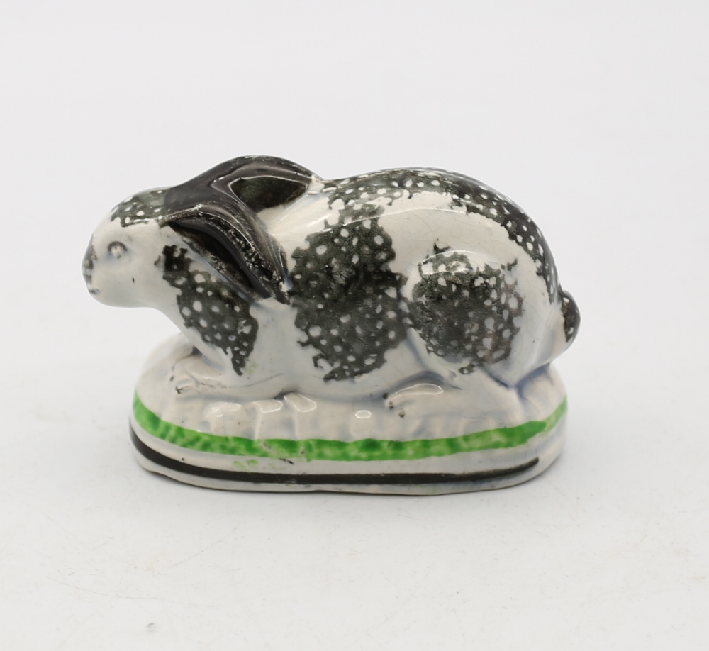 A Staffordshire pottery Rabbit crouched on an oval base, black sponged markings,  with green and - Image 3 of 5