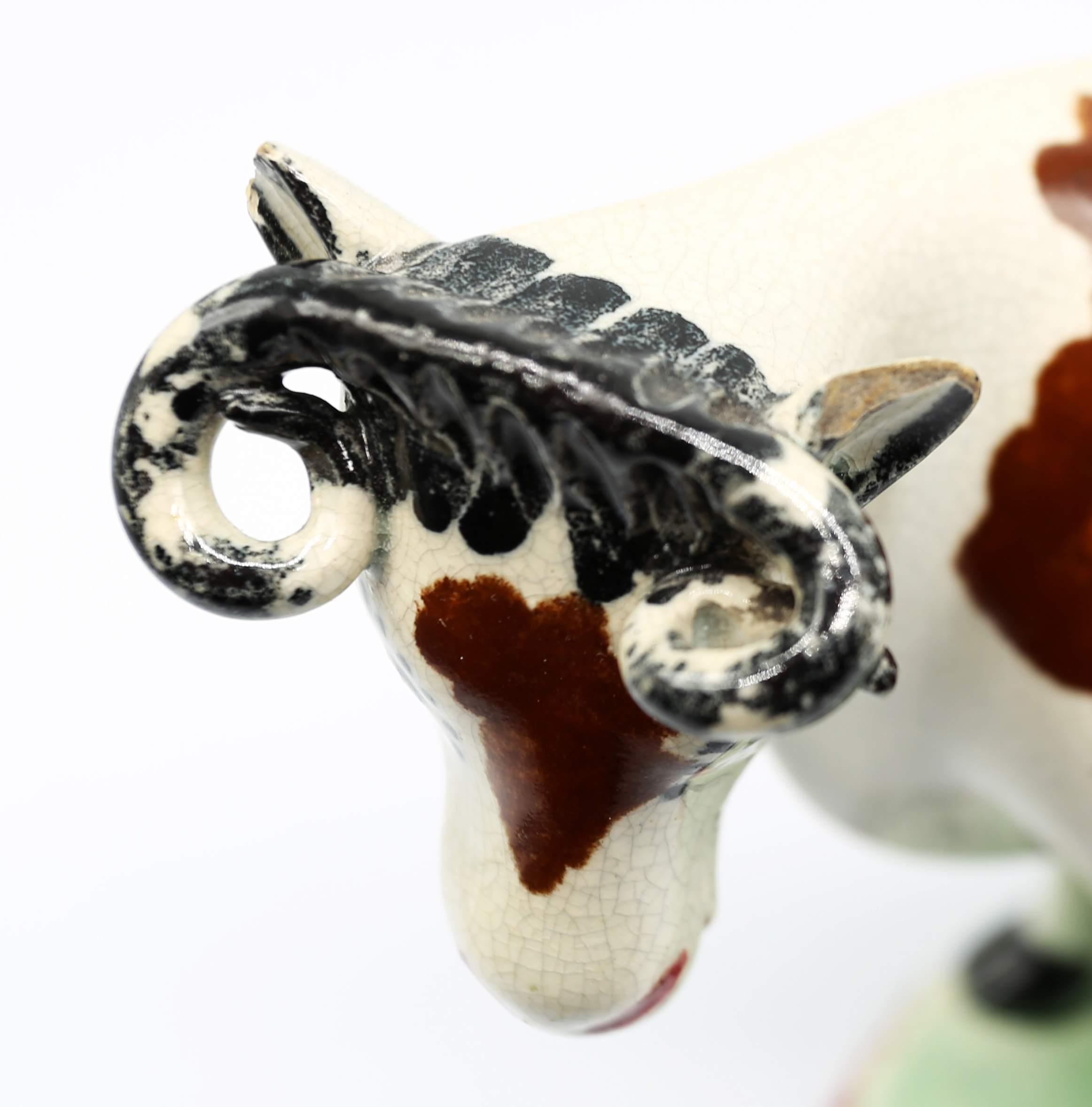 A North country pottery cow creamer and cover, standing on a green base with a mottled coloured base - Image 12 of 13