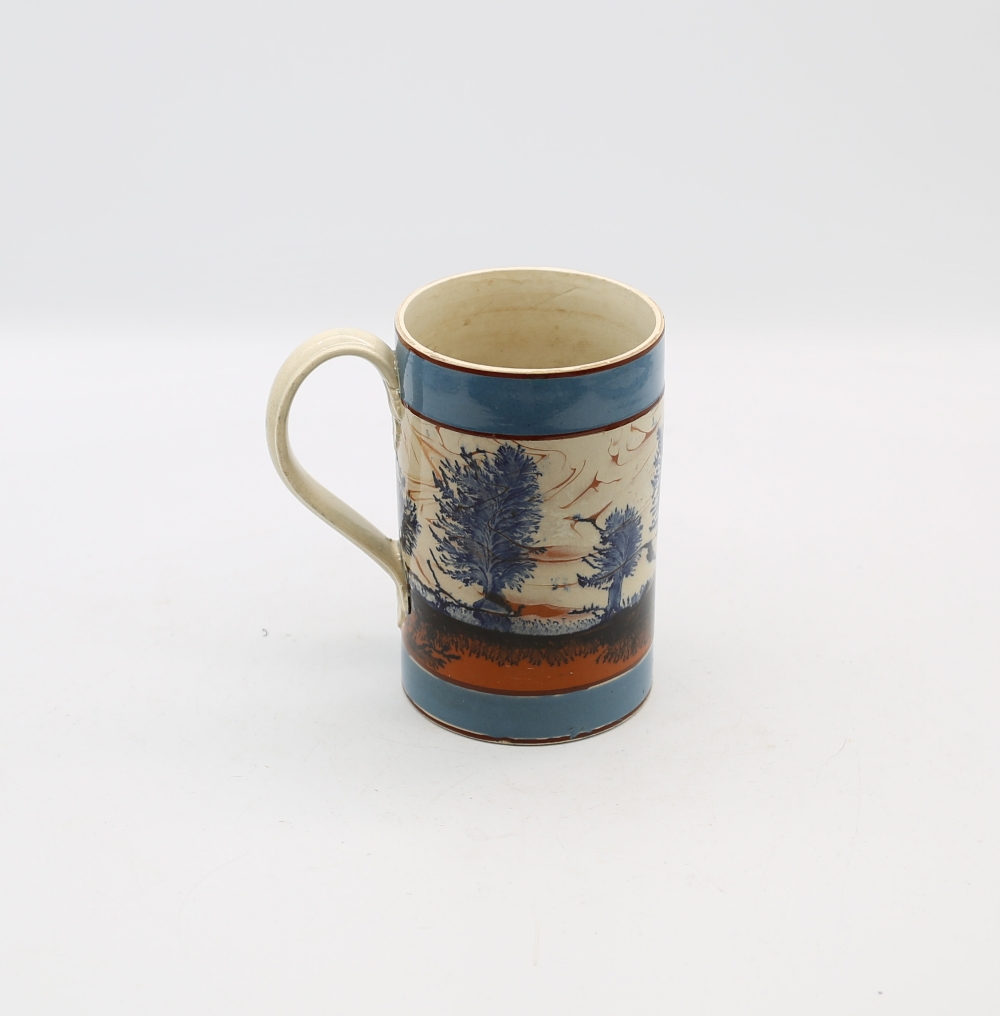 A mocha cylindrical mug, with blue feathered blue trees and a tan and black landscape and wide - Image 3 of 6