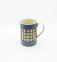 A creamware mug. Quart size with pale blue bands to top and foot rims and narrow orange bands  and