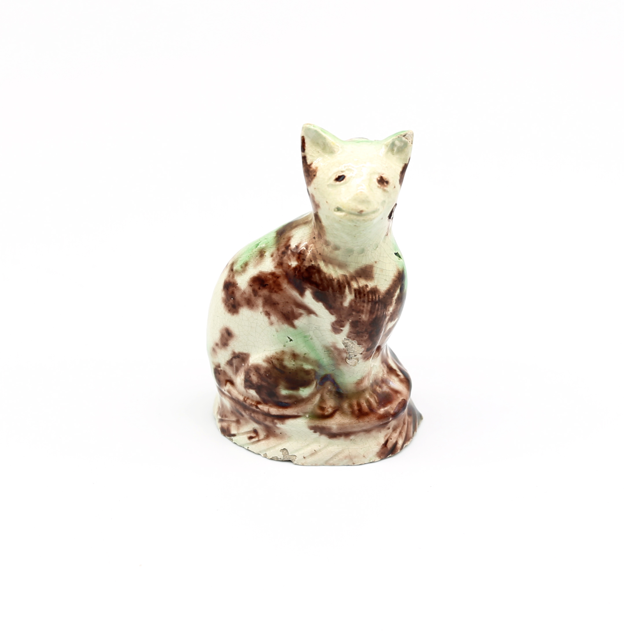 A small Staffordshire Whieldon creamware seated cat, sponge decorated in shades of green and brown