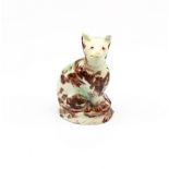 A small Staffordshire Whieldon creamware seated cat, sponge decorated in shades of green and brown