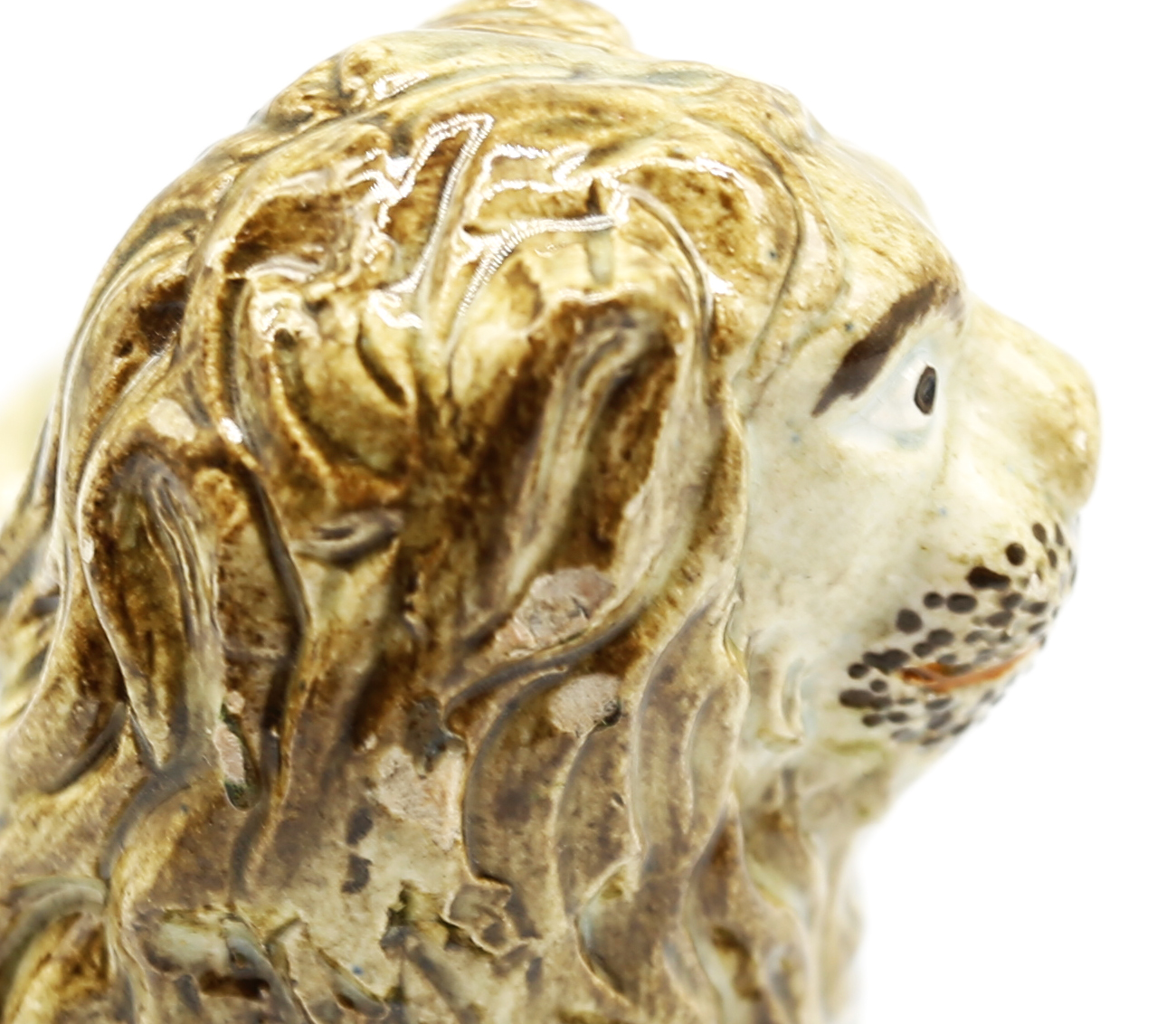A pearlware model of a recumbent lion laying on a grassy mound on a base with moulded relief.  Circa - Image 6 of 8