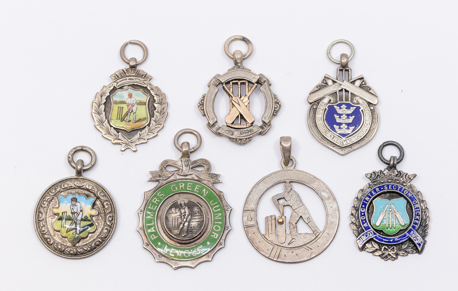 A collection of seven assorted silver hallmarked cricket fobs, to include: Palmers Green Junior