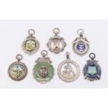 A collection of seven assorted silver hallmarked cricket fobs, to include: Palmers Green Junior