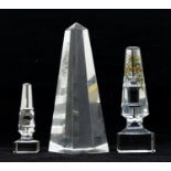 Three glass desk sculptures, one with hand painted design, Cleopatras needle and another.