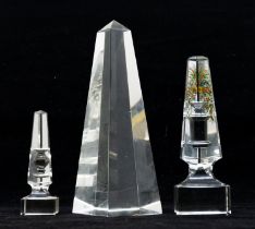 Three glass desk sculptures, one with hand painted design, Cleopatras needle and another.