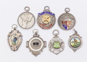 A collection of seven assorted silver hallmarked sporting fobs, to include: bowls, dominoes, darts