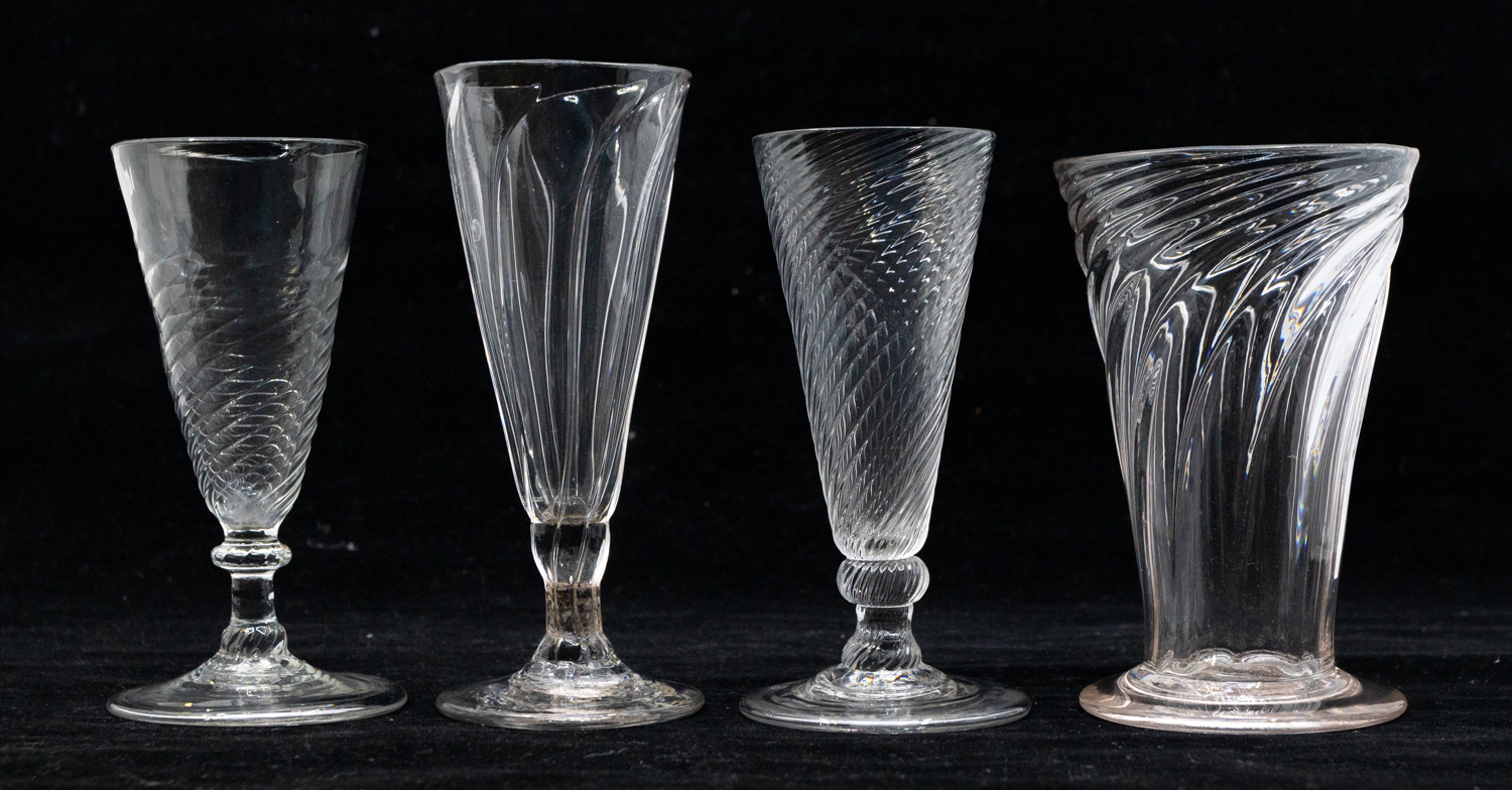 Four late 18th Century/early 19th Century twist cordial glasses, all different examples, on round
