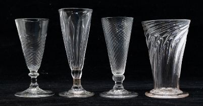 Four late 18th Century/early 19th Century twist cordial glasses, all different examples, on round