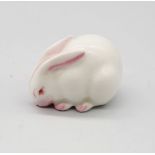 A Royal Worcester netsuke modelled as a white Rabbit, circa 1913, with green stamp underneath,