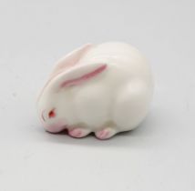 A Royal Worcester netsuke modelled as a white Rabbit, circa 1913, with green stamp underneath,