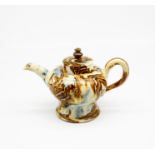An 18th century Agate teapot and cover, with a blue and brown wash,  Circa 1750.  Size 11cm high