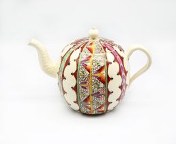 A Staffordshire Wedgwood creamware teapot and cover, painted in bright enamels with the ‘Chintz’