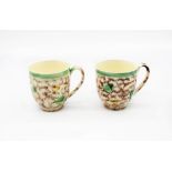 Two Whieldon style creamware coffee cups decorated in copper manganese and yellow.  Circa 1770.