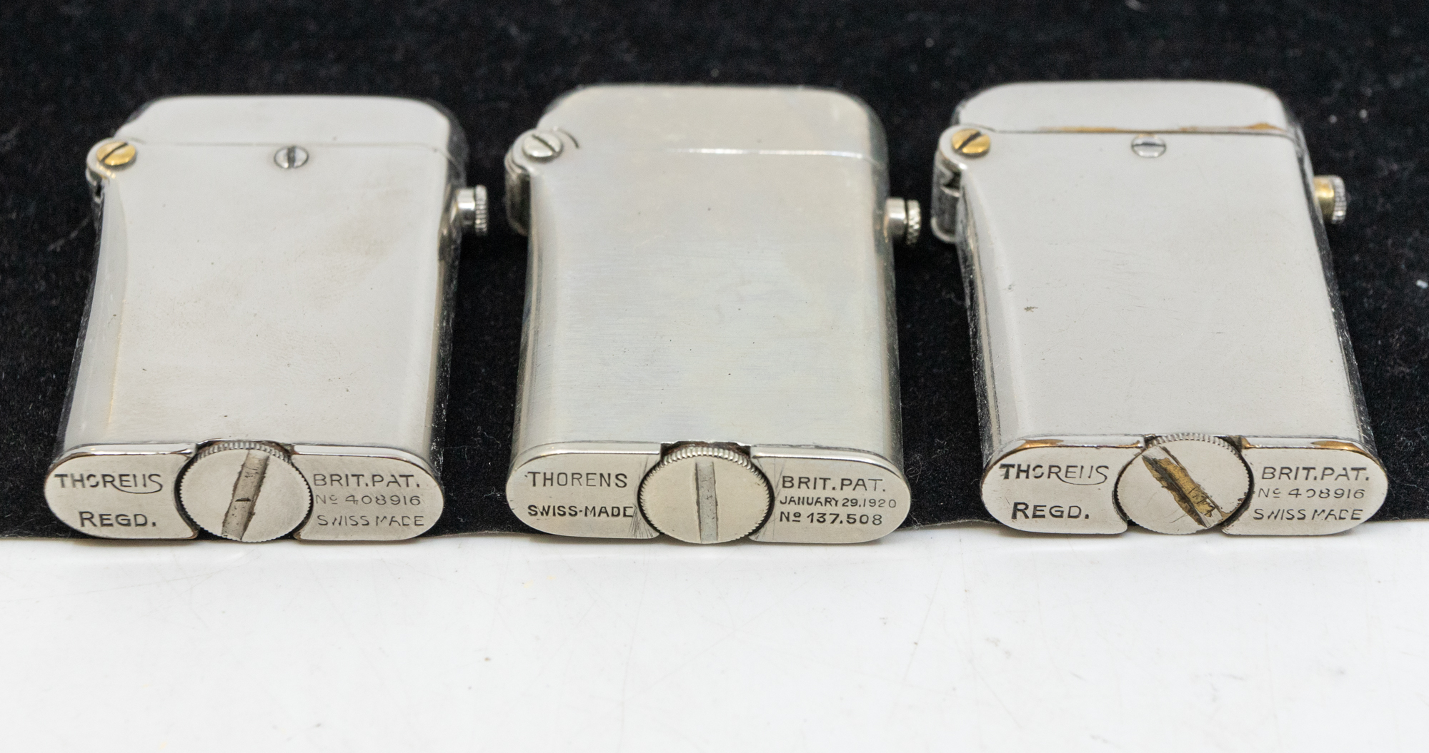 A collection of five Thorens plated or steel cased lighters, all of same rectangular shape with - Bild 3 aus 4